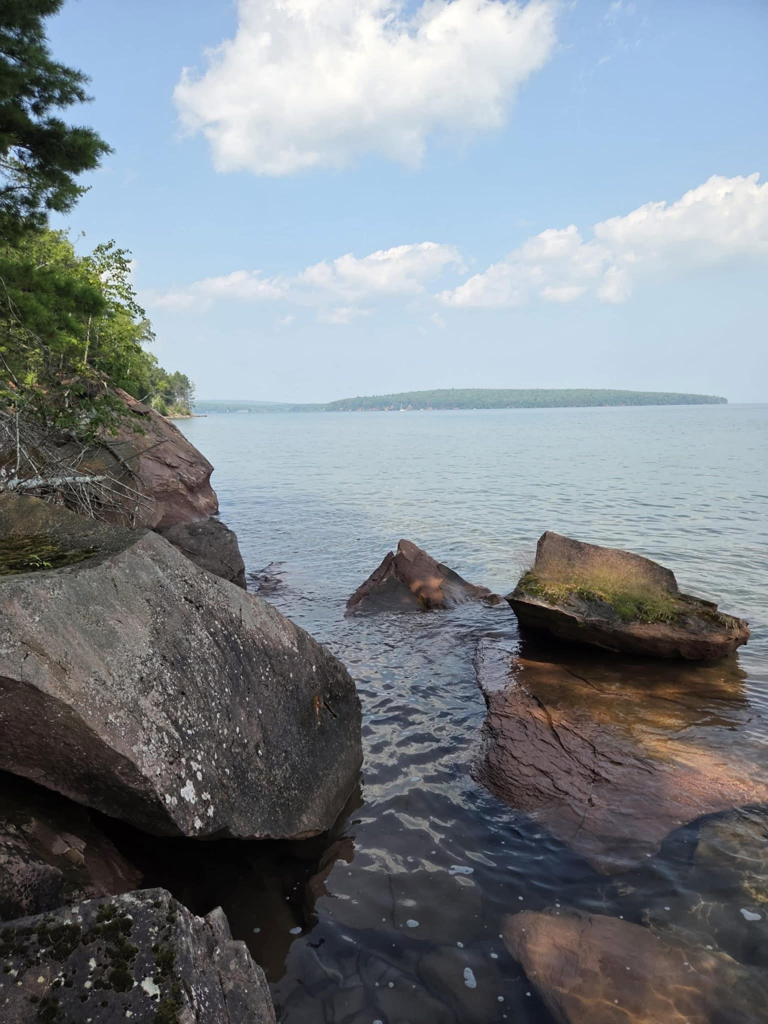 Red sandstone rocks in clear Lake Superior water
